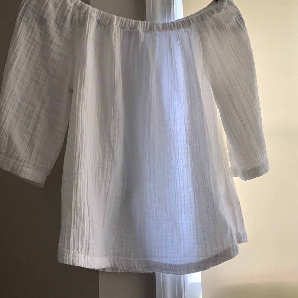 Beach lunch lounge. Small white delicate top.
